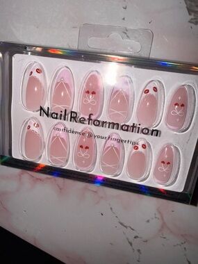 Nail Reformation Pink Press-On Nails with Red Cherry Accents & Bows.